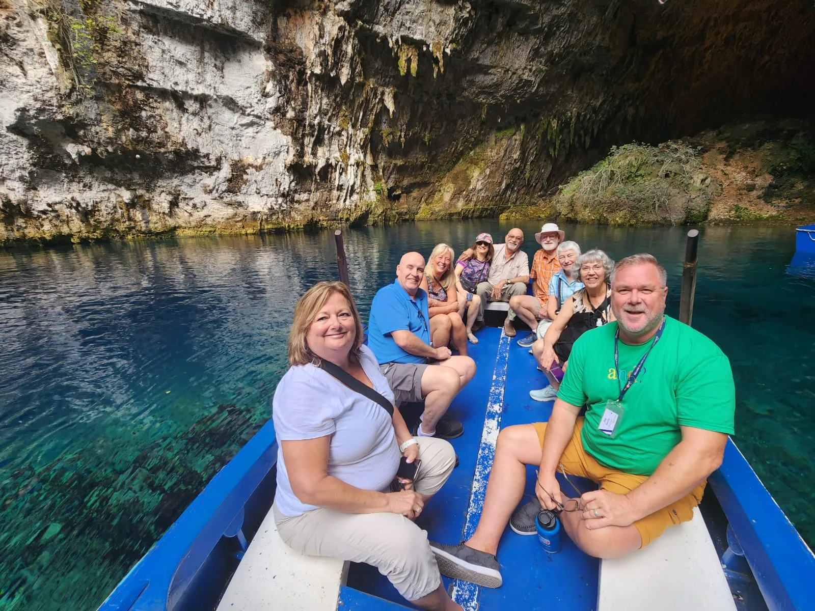 Travellers smiling on a boat ride through the Drongarati Caves