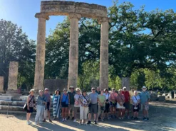 Travellers smiling in front of Olympia