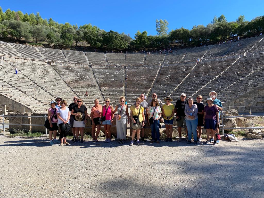 Travellers smiling in the Epidaurus ancient theatre